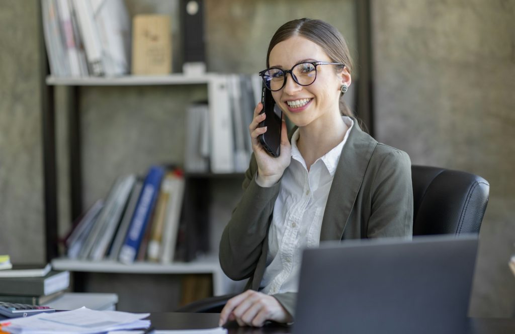 Attractive successful elderly business Asian woman in striped blouse working in modern office, makin