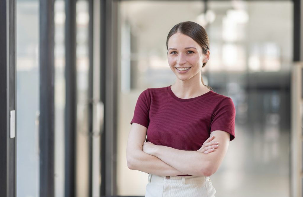 Portrait of Young canada american business woman in modern office, financial report, business plan